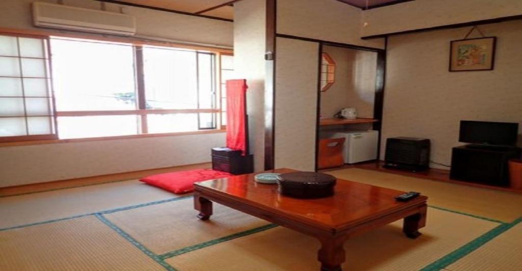 a living room with a coffee table and a television at Oyado Matsubaya / Vacation STAY 8065 in Obinata