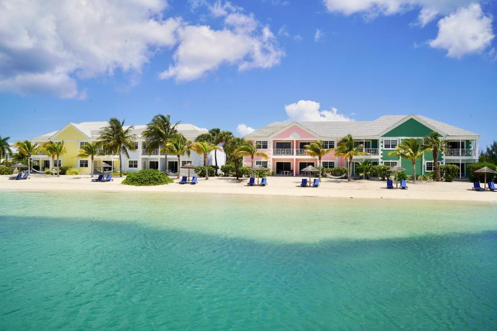 a house on a beach with the water at Sandyport Beach Resort in Nassau