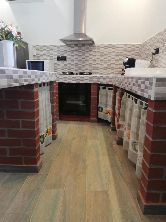 a kitchen with a red and white brick counter top at Villa Frane 101 in Beli