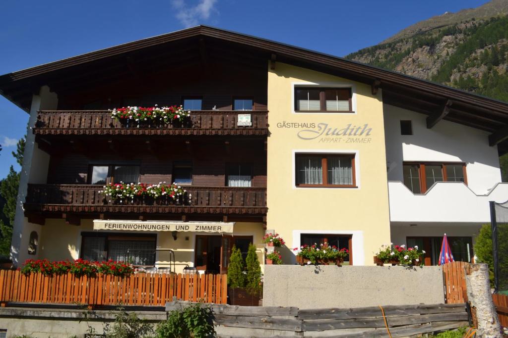 a large building with flowers on the balconies at Gästehaus Judith in Sölden