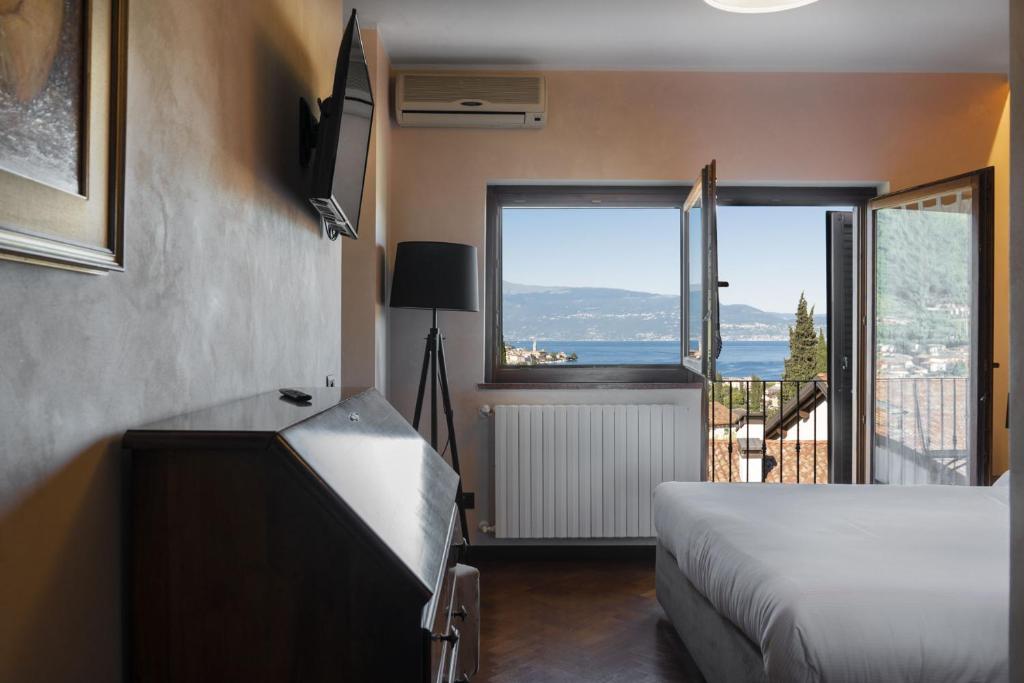 a bedroom with a bed and a view of the ocean at La Villa in Salò
