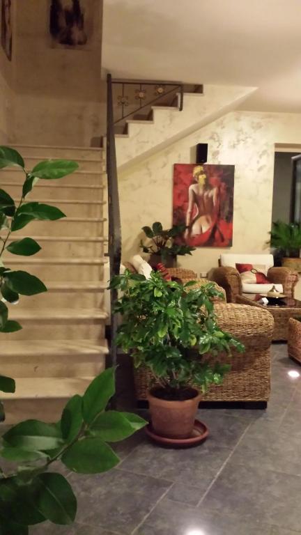 a living room with a staircase and a couch at Borgo di Santa Barbara in Santa Domenica