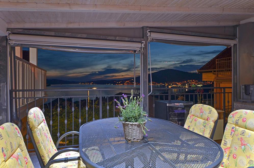 a table and chairs on a balcony with a view at Apartments Tomislav in Trogir