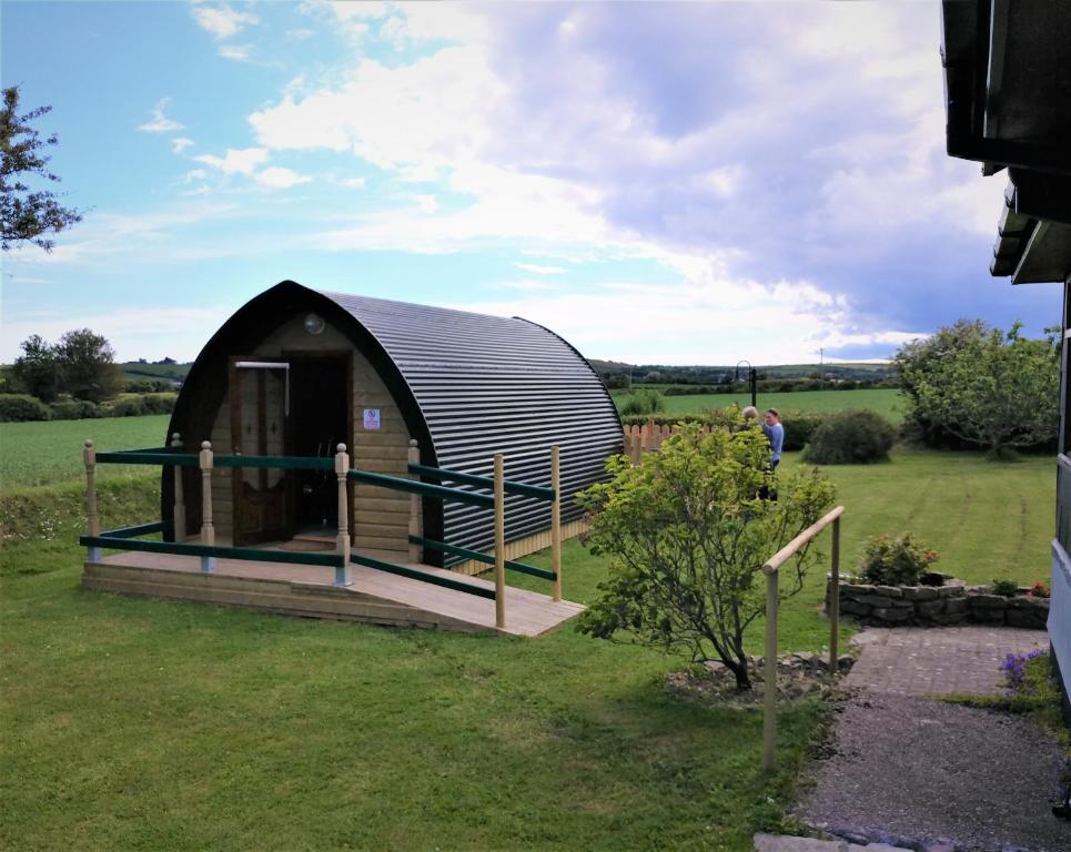 a circular dome house in a field of grass at shanagarry / Ballycotton Glamping pod in Cork