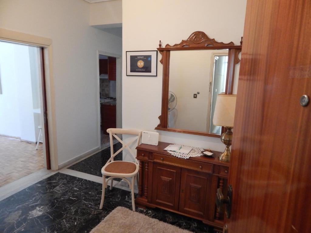 a room with a desk with a mirror and a chair at Zira Holiday House in Makrygialos