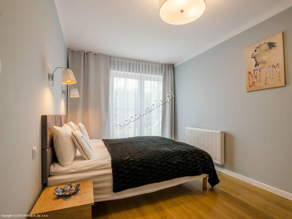 Postel nebo postele na pokoji v ubytování VILLA VARSOVIA ROWY