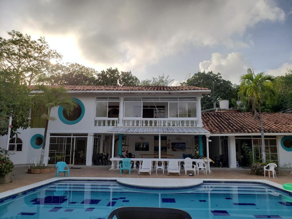 a villa with a swimming pool and a house at Coral House San Andres in San Andrés