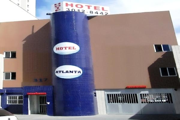 a hotel with two signs on the side of a building at Hotel Atlanta in Salvador