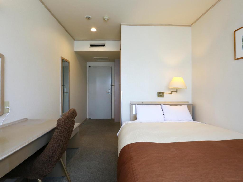 Postel nebo postele na pokoji v ubytování Chino Sky View Hotel