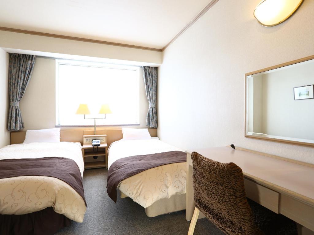 Postel nebo postele na pokoji v ubytování Chino Sky View Hotel