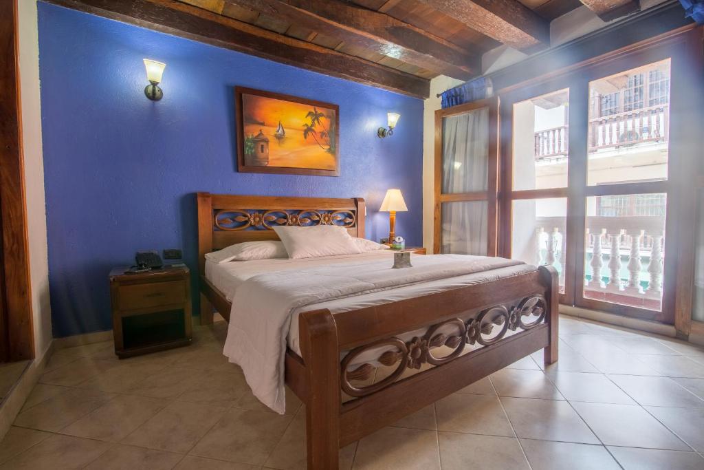 Postel nebo postele na pokoji v ubytování Hotel Don Pedro De Heredia