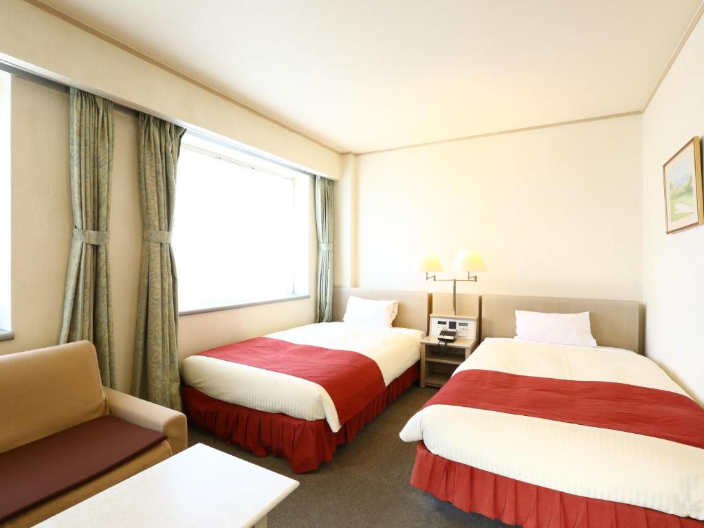 Postel nebo postele na pokoji v ubytování Chino Sky View Hotel