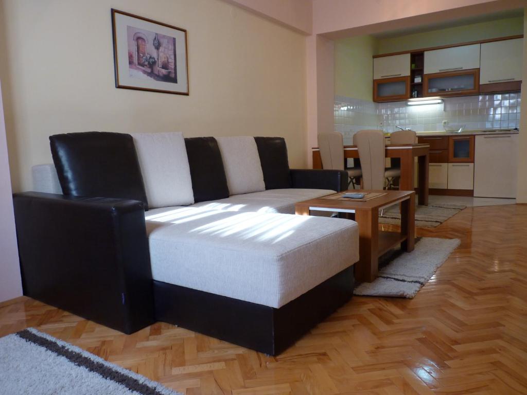 a living room with a couch and a table at Adeona Apartments in Ohrid