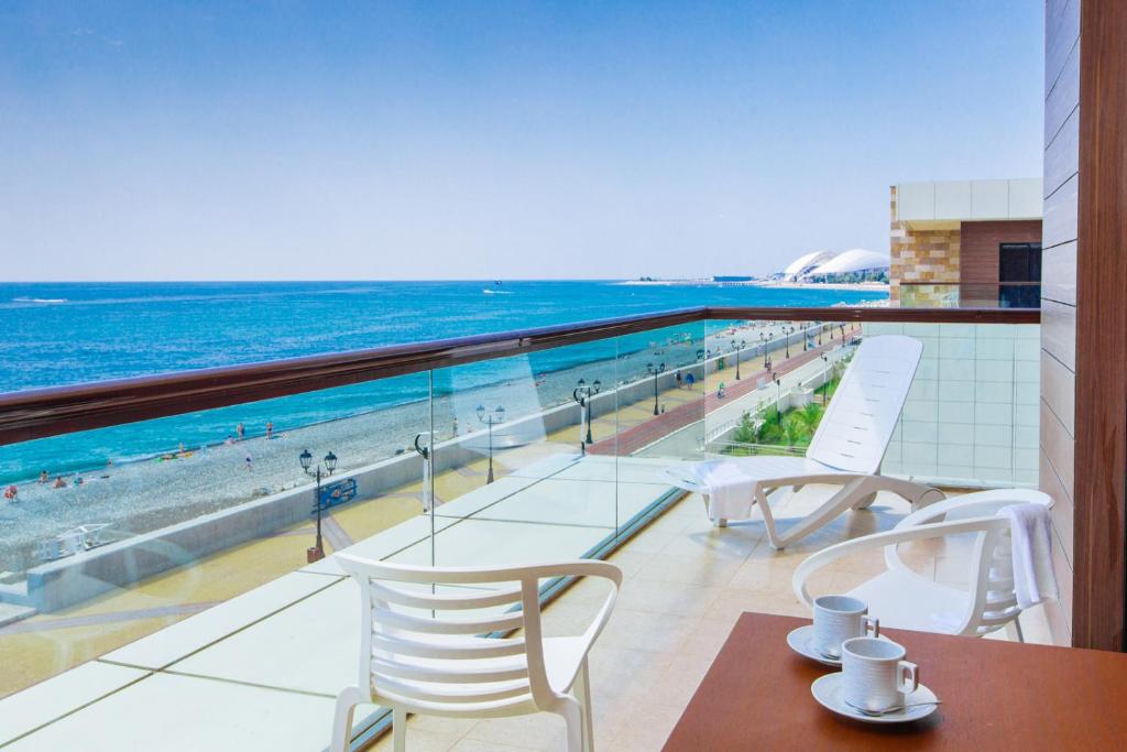 a balcony with a view of the beach and the ocean at Arfa Park-Hotel in Adler