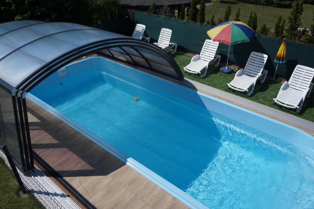 a swimming pool with a cover on top of it at Villa Clipper - 5 minut od plaży in Grzybowo