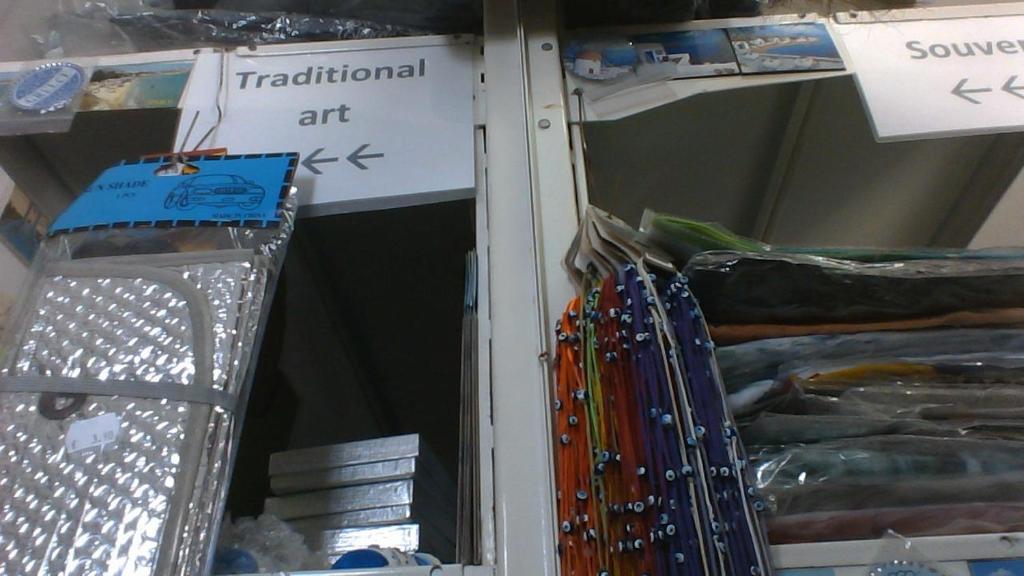a group of different colored pens on a shelf at Paroscarmel studio-apartment in Logaras