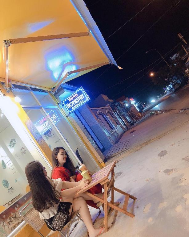 a woman sitting in a chair on the beach at night at Homestay BONO Mũi Né in Phan Thiet