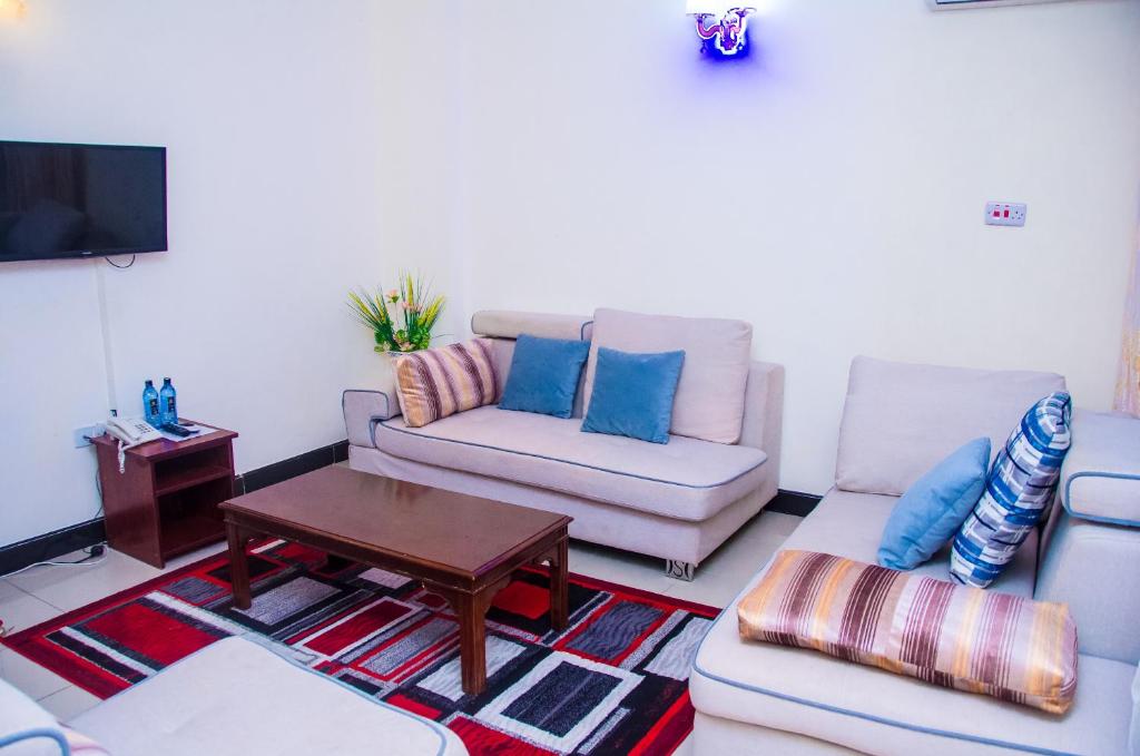 a living room with two couches and a coffee table at Sheratton Regency Hotel in Mombasa