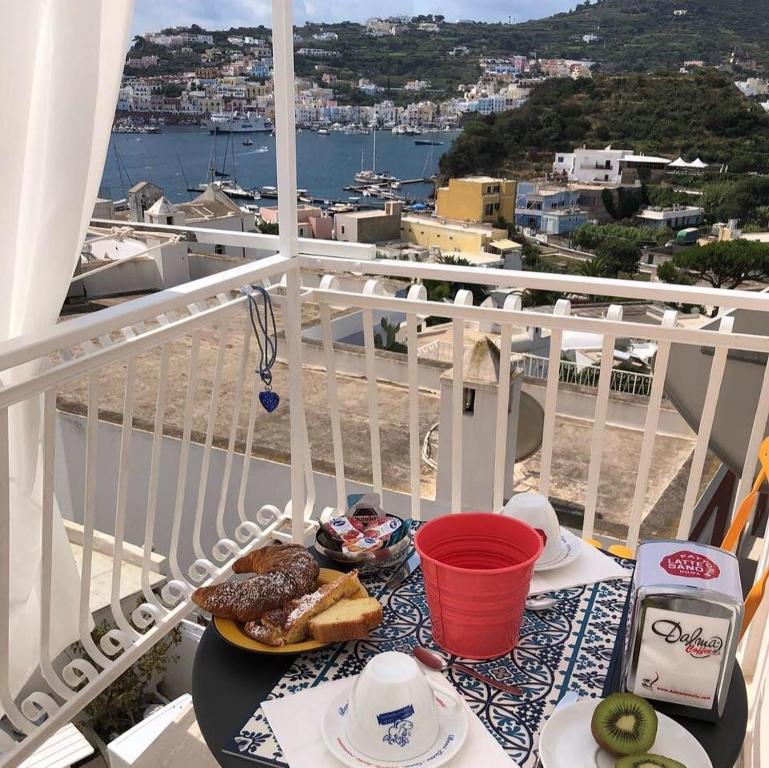 una mesa con un plato de comida en el balcón en B&B Ponza Suite en Ponza