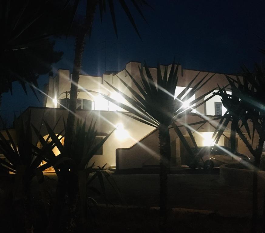 a house with lights on the side of it at night at Villa Iavernaro in Pulsano