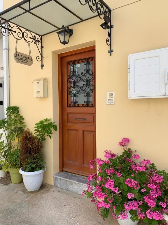a front door of a house with flowers at Ifigenia Apartments in Ermoupoli