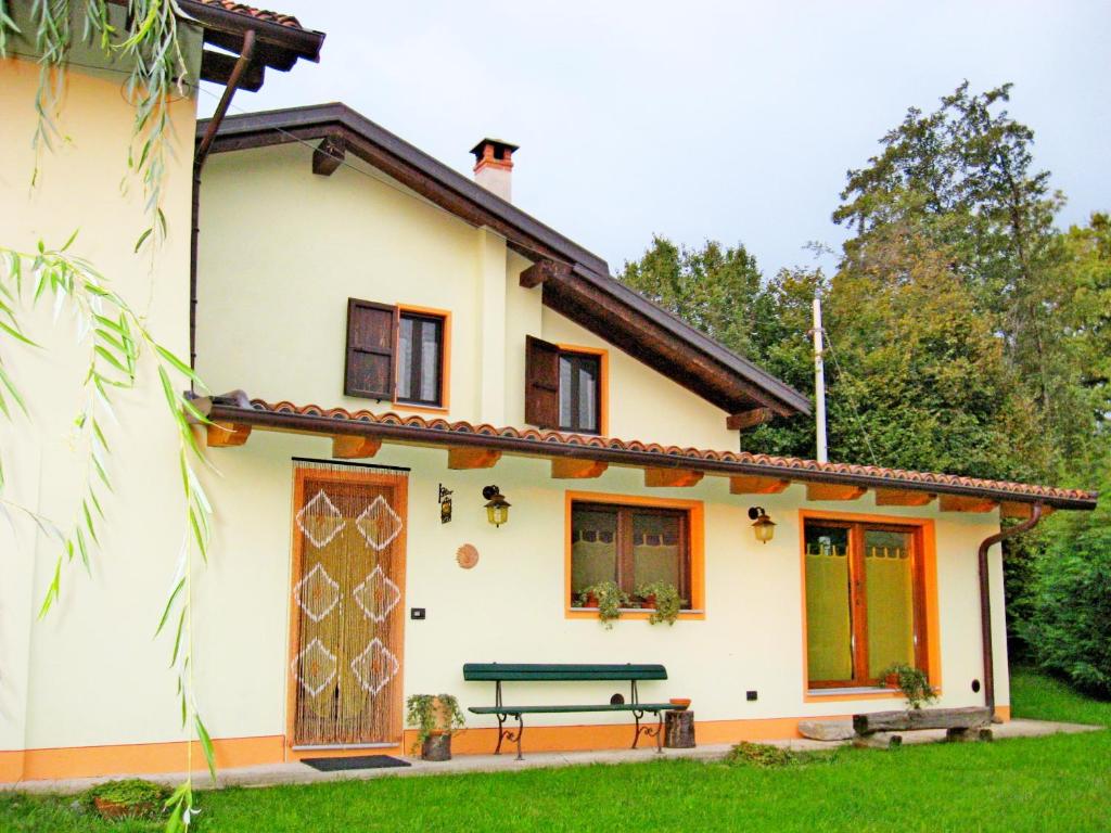 a house with a bench in front of it at B&B La Coccinella Biologico in Graglia