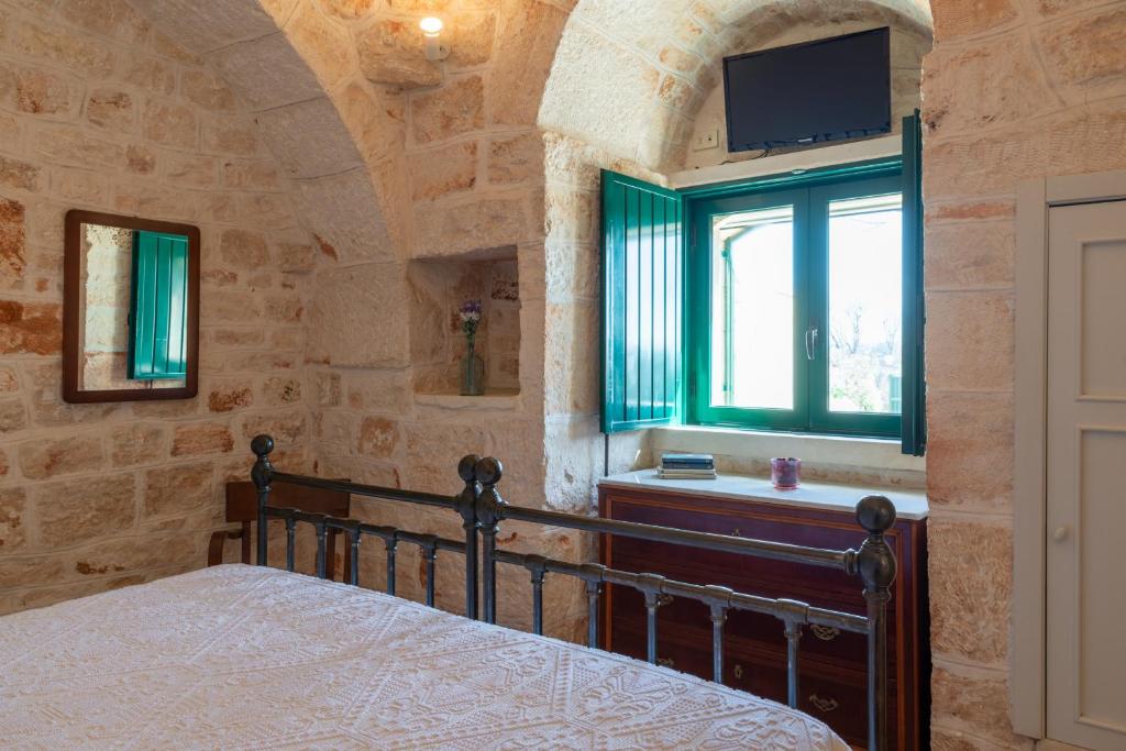 Posteľ alebo postele v izbe v ubytovaní Stile e relax nei trulli by Wonderful Italy