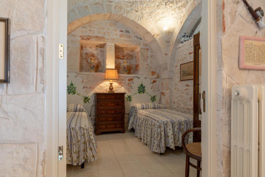 Posteľ alebo postele v izbe v ubytovaní Stile e relax nei trulli by Wonderful Italy