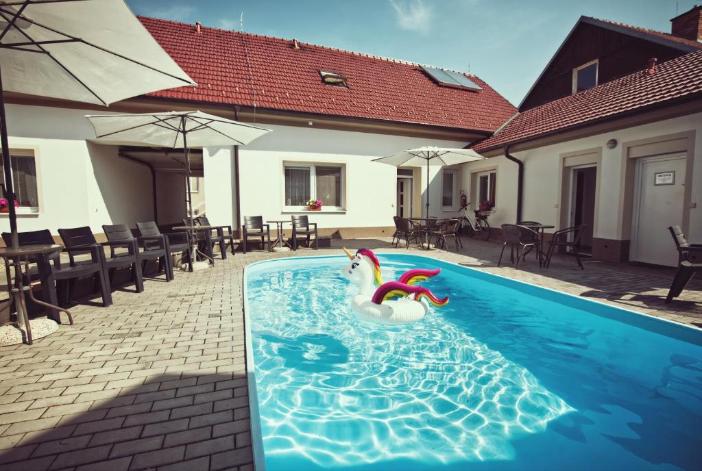 a swimming pool with a swan in the water at Penzion Kratochvíl in Dolní Dunajovice