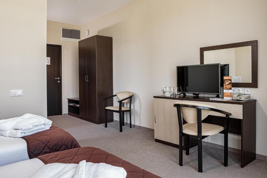 Postel nebo postele na pokoji v ubytování Barkhatnye Sezony Sportivny Kvartal Resort