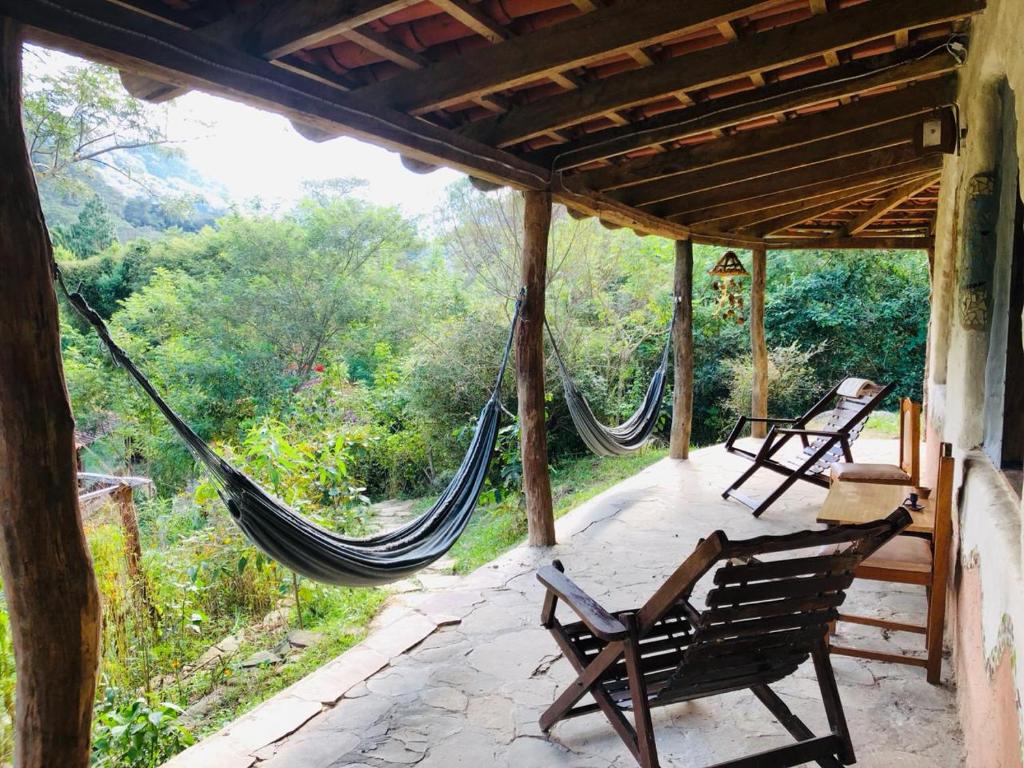 a porch of a house with hammocks on it at Quinta Conciencia in Samaipata