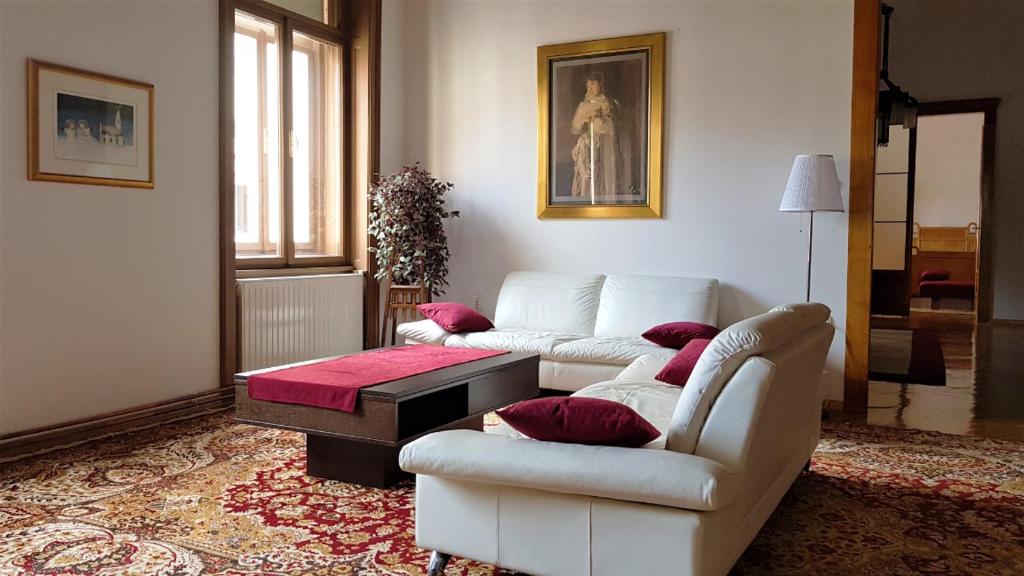 a living room with two couches and a coffee table at Luxury apartment in the heart of Varazdin in Varaždin