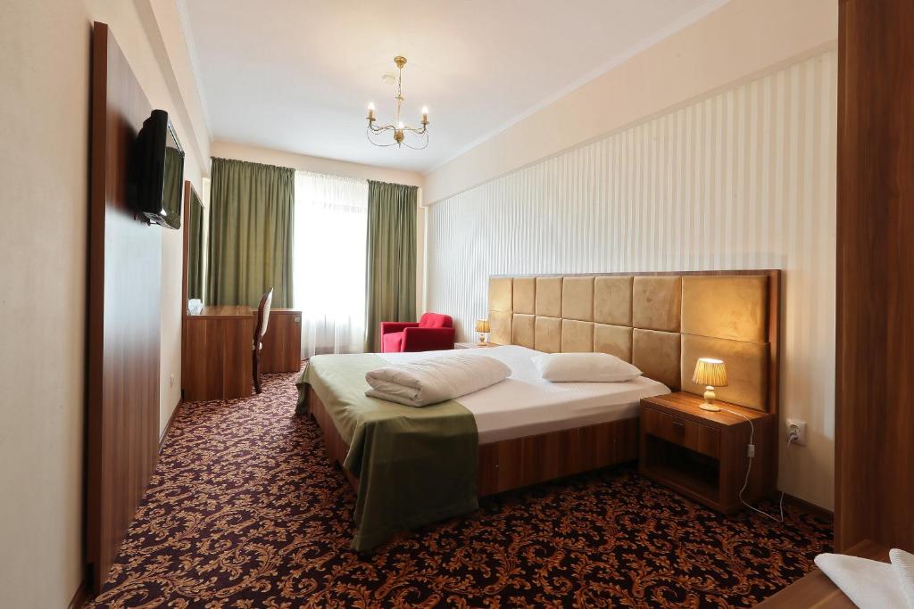 Postel nebo postele na pokoji v ubytování Hotel Impero