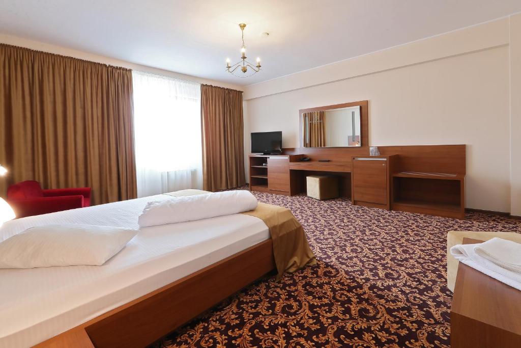 Postel nebo postele na pokoji v ubytování Hotel Impero