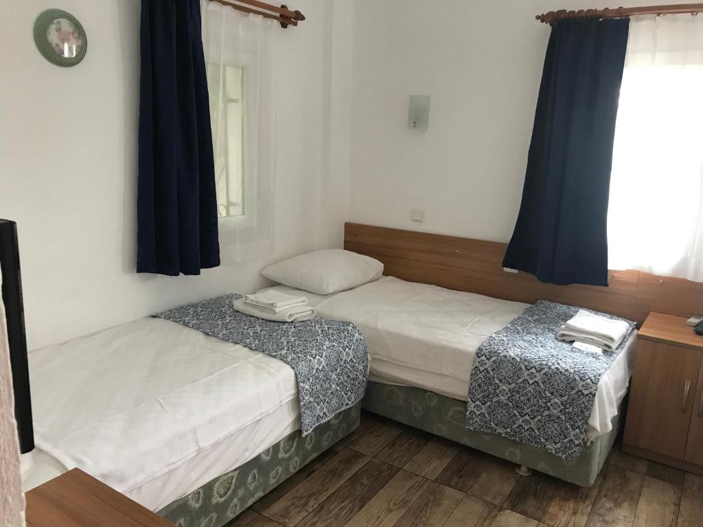 Postel nebo postele na pokoji v ubytování Tay Pansiyon