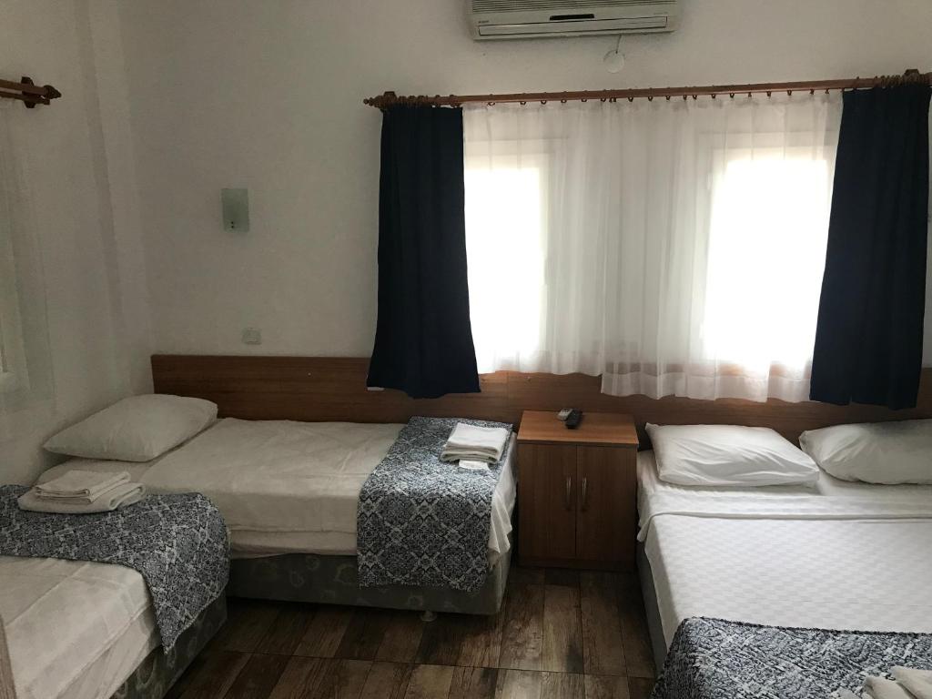 Postel nebo postele na pokoji v ubytování Tay Pansiyon