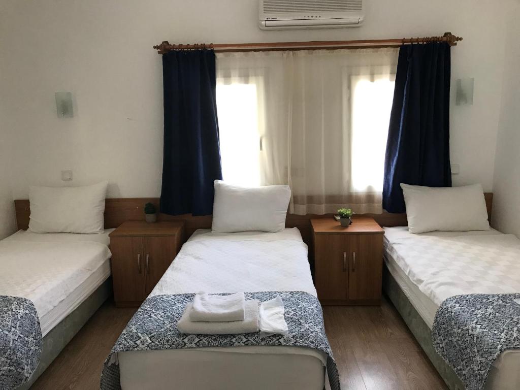 Postel nebo postele na pokoji v ubytování Tay Pansiyon