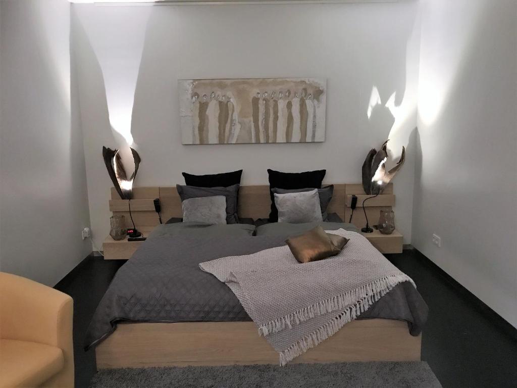 a bedroom with a bed and a painting on the wall at WK12 Suite in Cuijk