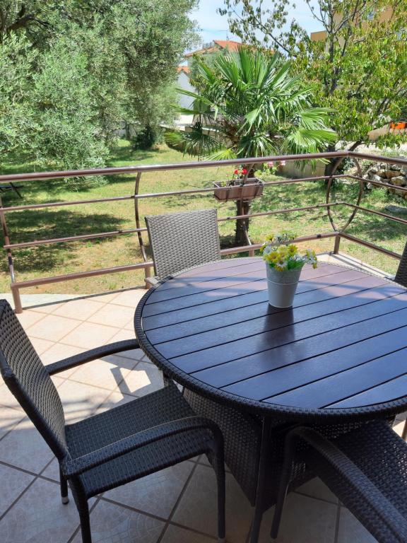 a blue table and chairs on a patio at Apartments Juretic in Drenje