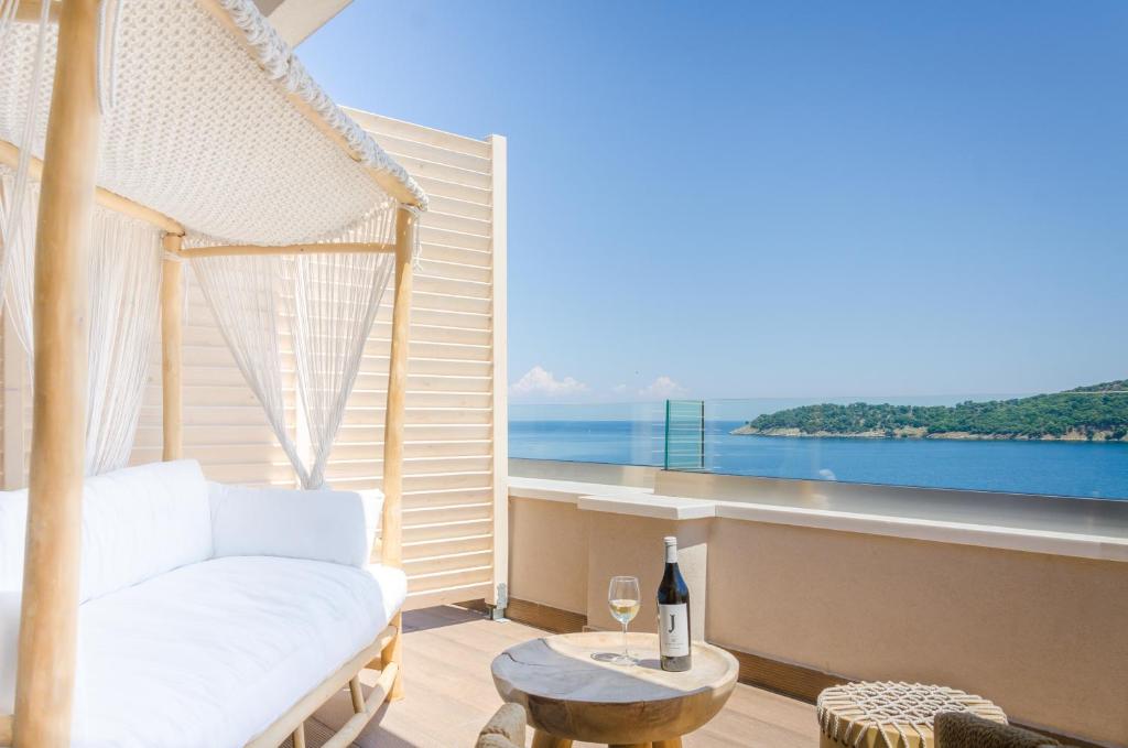a living room with a white couch and a view of the ocean at Agorastos Hotel in Koinyra