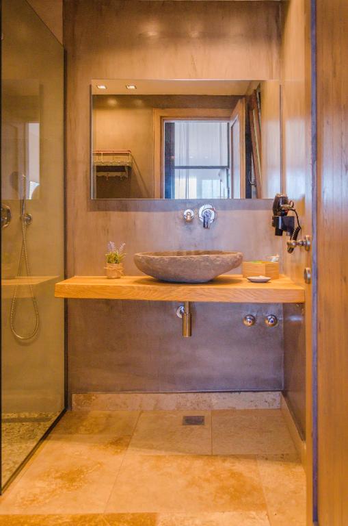a bathroom with a wooden counter with a sink at Agorastos Hotel in Koinyra