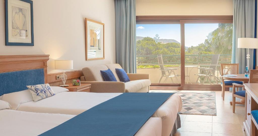 a hotel room with a bed and a balcony at SH Villa Gadea in Altea