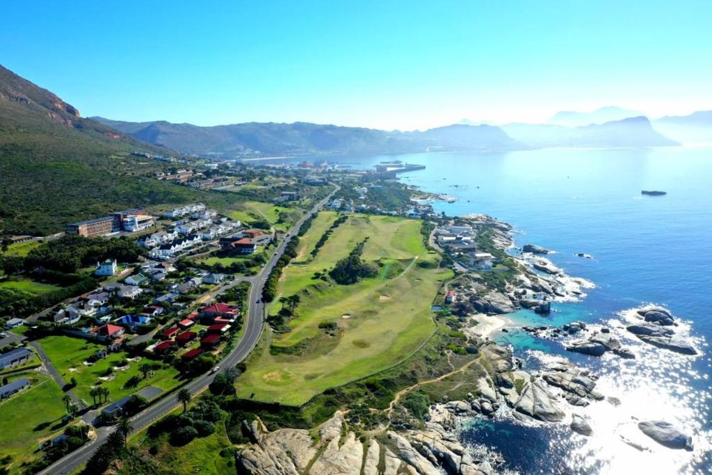 an aerial view of a town next to the ocean at Porcupine Walk in Simonʼs Town