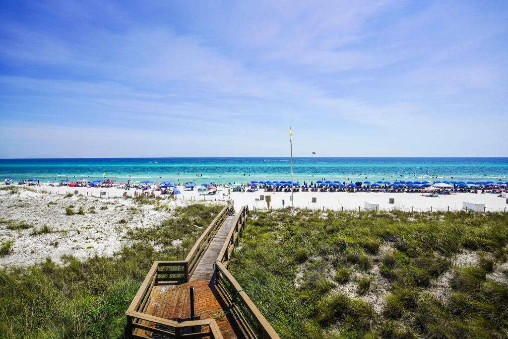 a view of a beach with umbrellas and the ocean at Emerald Beach by Panhandle Getaways in Panama City Beach