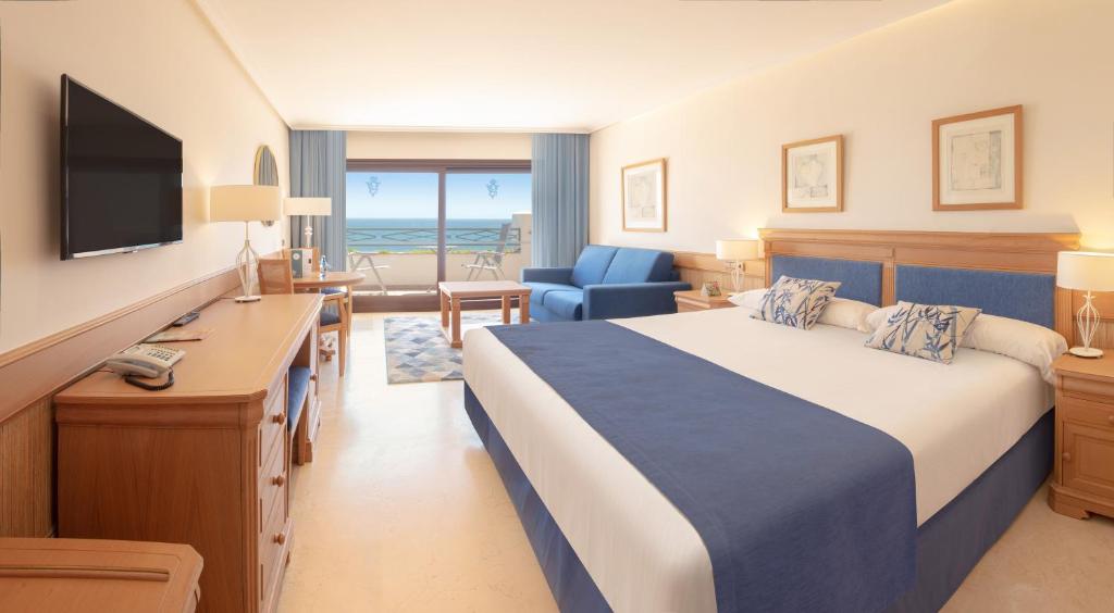 
a hotel room with a large bed and a large window at SH Villa Gadea in Altea
