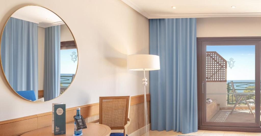 a room with a mirror and a table with a lamp at SH Villa Gadea in Altea