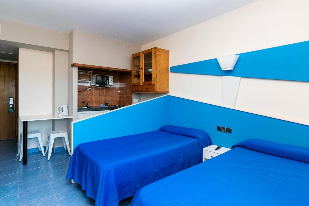 a bedroom with blue walls and a blue bed at The Blue Apartments - Adults Only in San Antonio