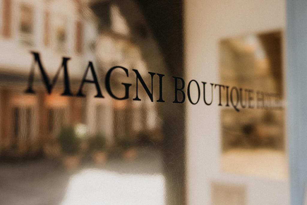 a sign on a window that reads merchant boutique at Magni Boutique Hotel in Braunschweig