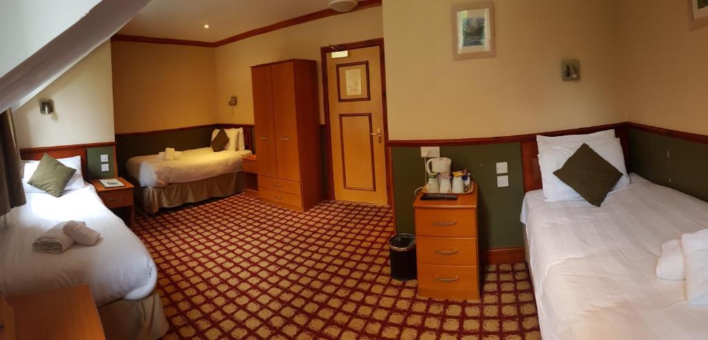 Postel nebo postele na pokoji v ubytování Clachaig Inn