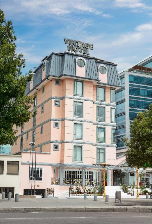 a building with a sign on top of it at Hotel Vintage in Bogotá